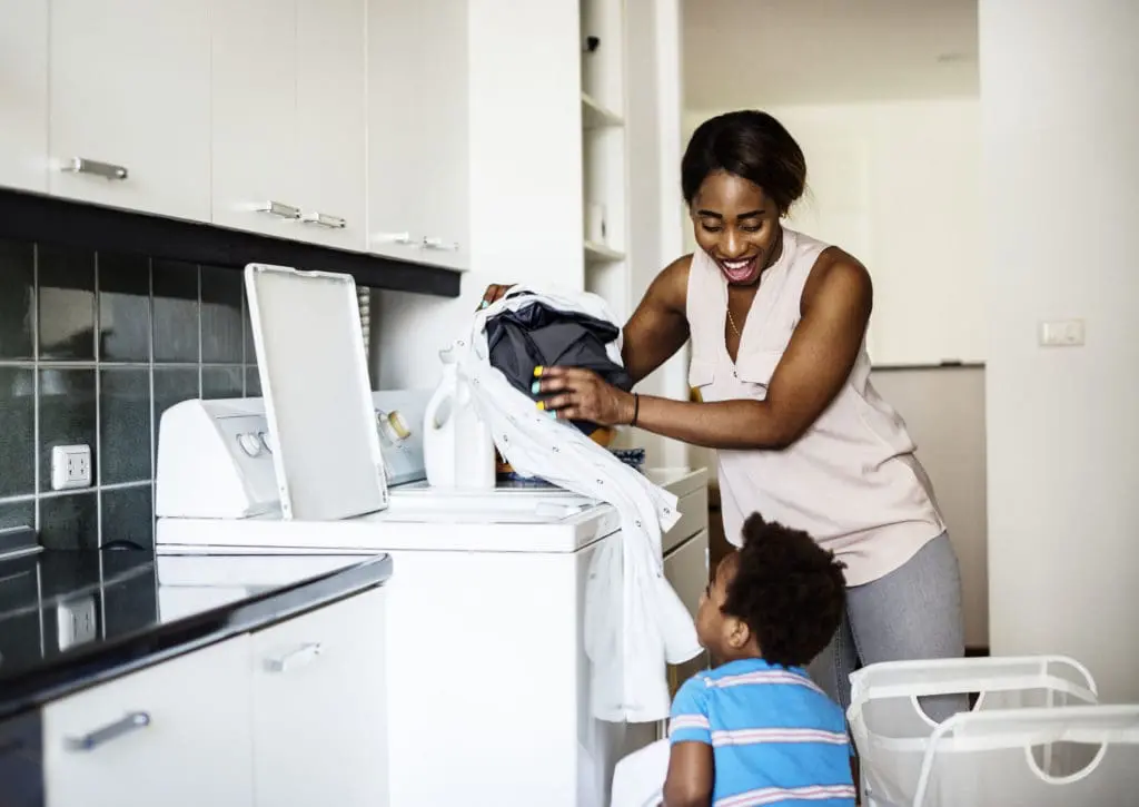 Mom and son doing laundry together.