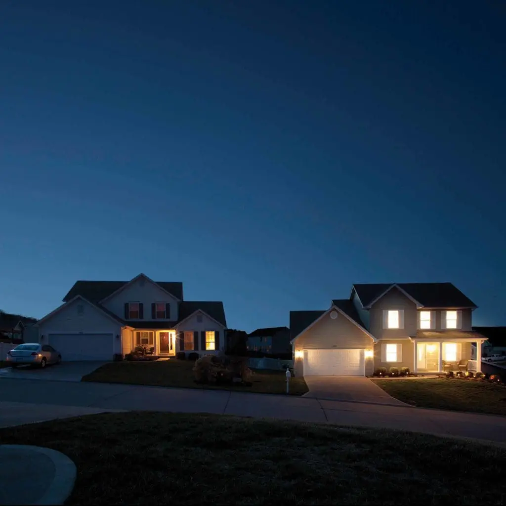 Two houses with lights on
