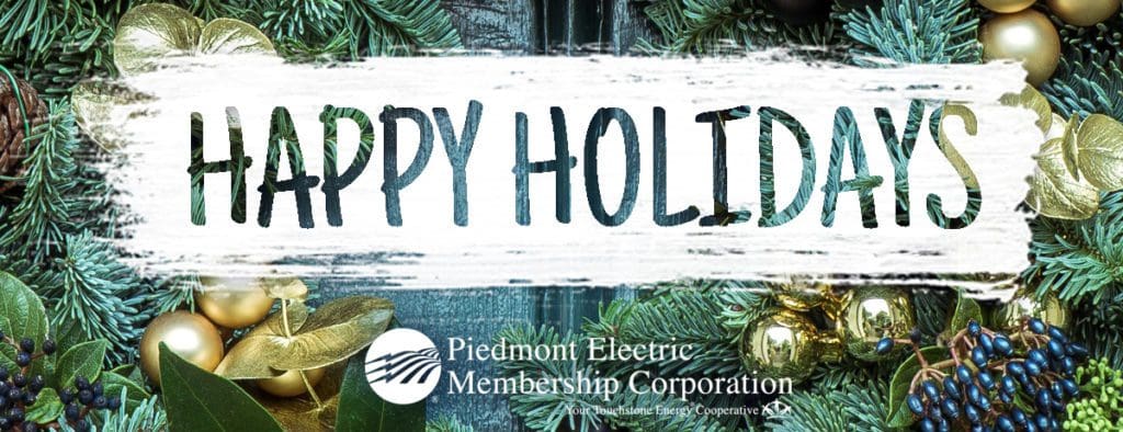 Happy holidays text with the Piedmont Electric logo. Background image is of a decorated tree.