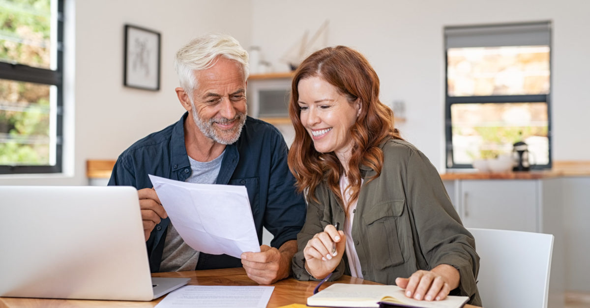 Couple reviewing bill with smiles