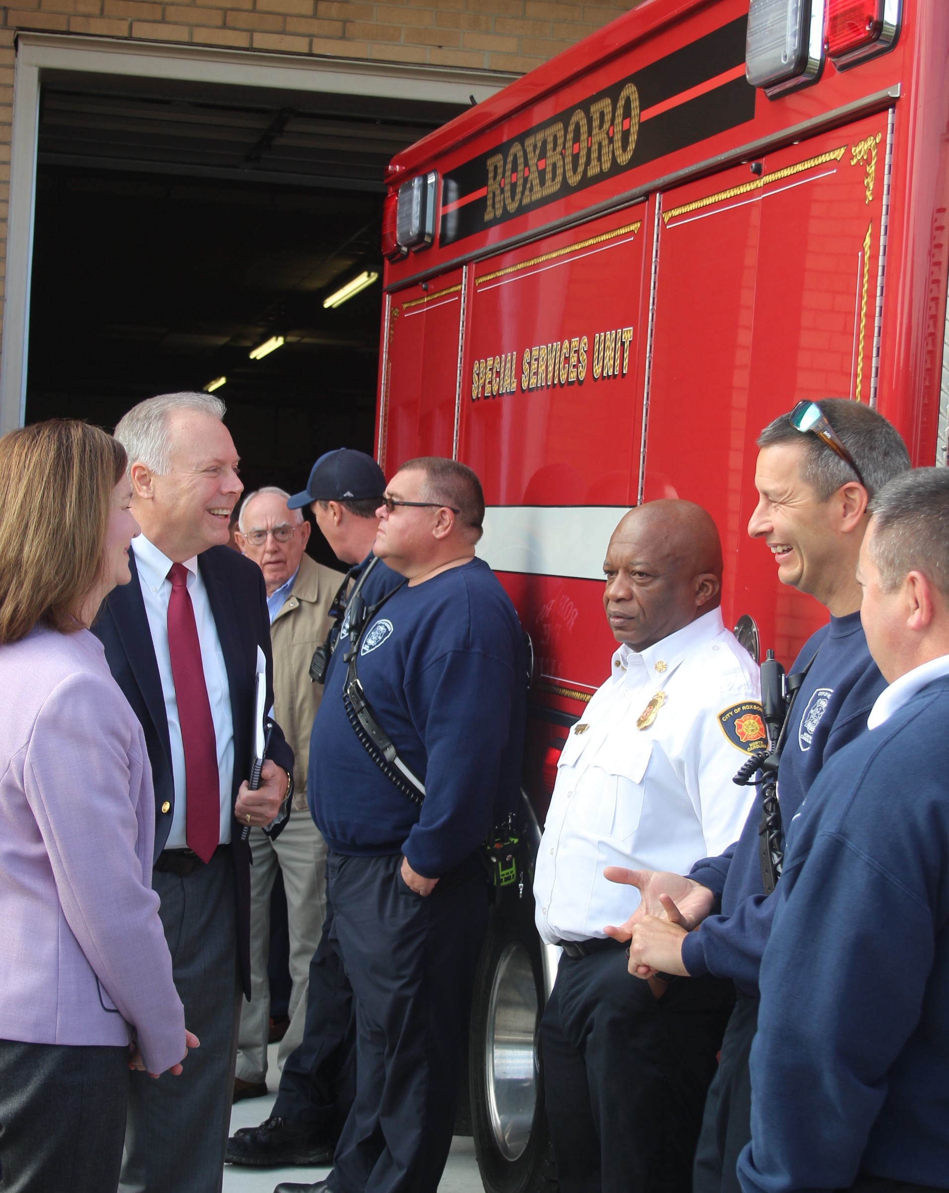 Photo caption: Chief Torain and representatives from Piedmont Electric discuss the City of Roxboro Fire and Rescue Department’s new air and light truck. 