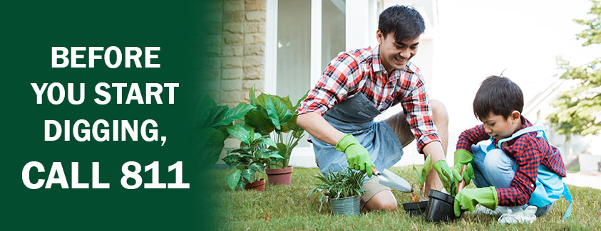 Before you start digging, call 811. Image of a dad and son planting outside.