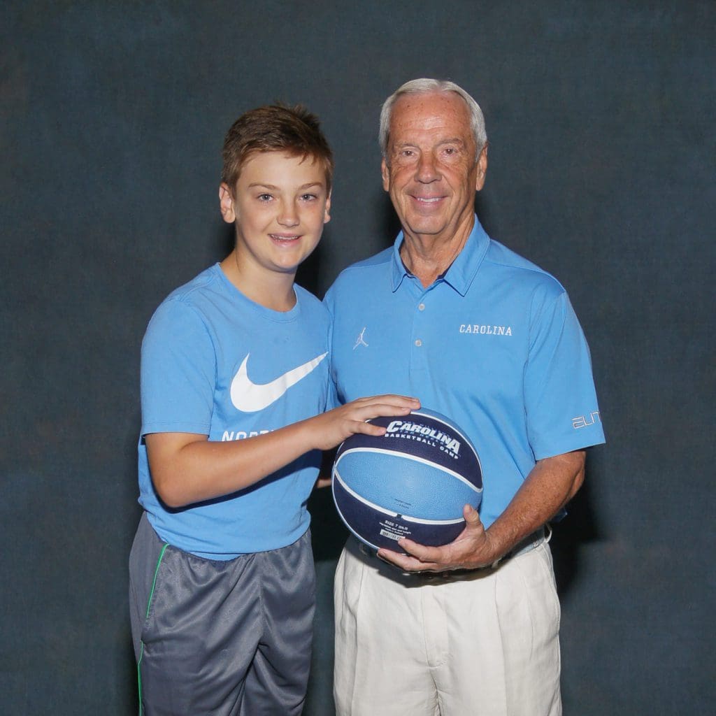 Student posing with coach at camp