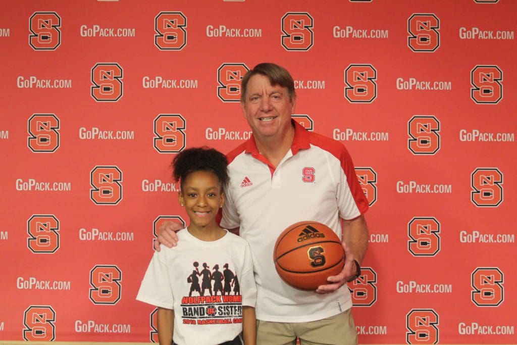 Student posing with coach at camp